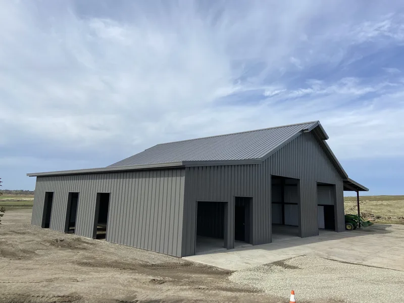Open-front pole barn under wide sky