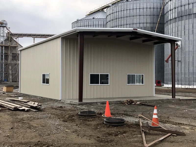 Agricultural steel building beside grain silos
