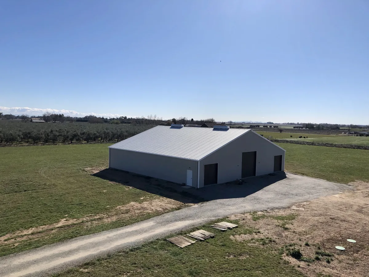 Steel agricultural building with multiple bays on a working farm